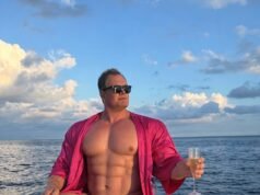 Alan Carr publica una divertida imagen de IA que muestra abdominales como una tabla de lavar mientras se relaja en un bote en pequeños Speedos mientras su exmarido comenta