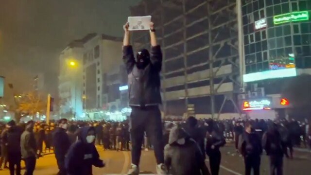 1768184785_iranian-protester-holding-sign.jpg