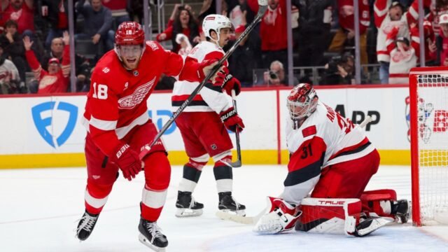 Detroit-Red-Wings-center-Andrew-Copp-left-celebrates-near-Carolina-Hurricanes-goaltender-Frederik-An.jpeg