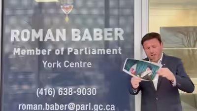 canada-mp-roman-baber-joins-iran-protest-trend-as-he-lights-cigar-with-khameneis-burning-photo.jpg