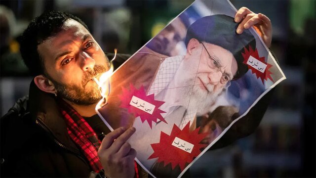iranian-refugee-burns-khamenei-image-cigarette-video-001.jpg